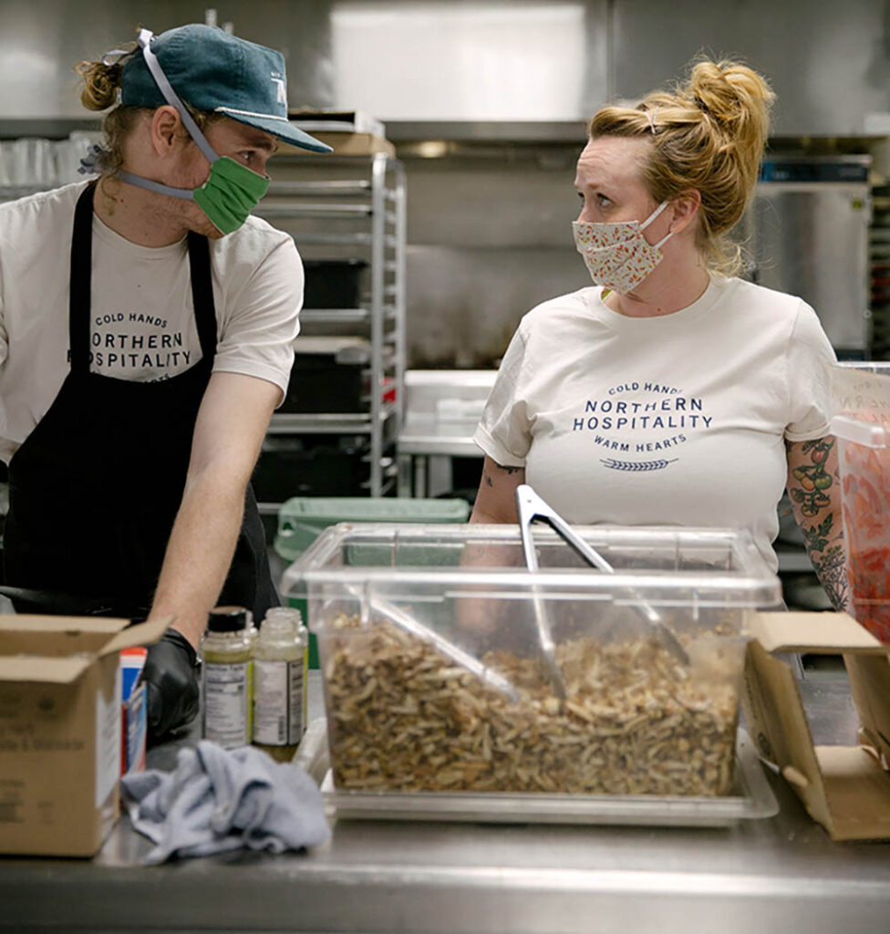 Minnesota Central Kitchen Cook Connor Cusak and Chowgirls Chef de Cuisine Arianna Baker-Kern prepare meals