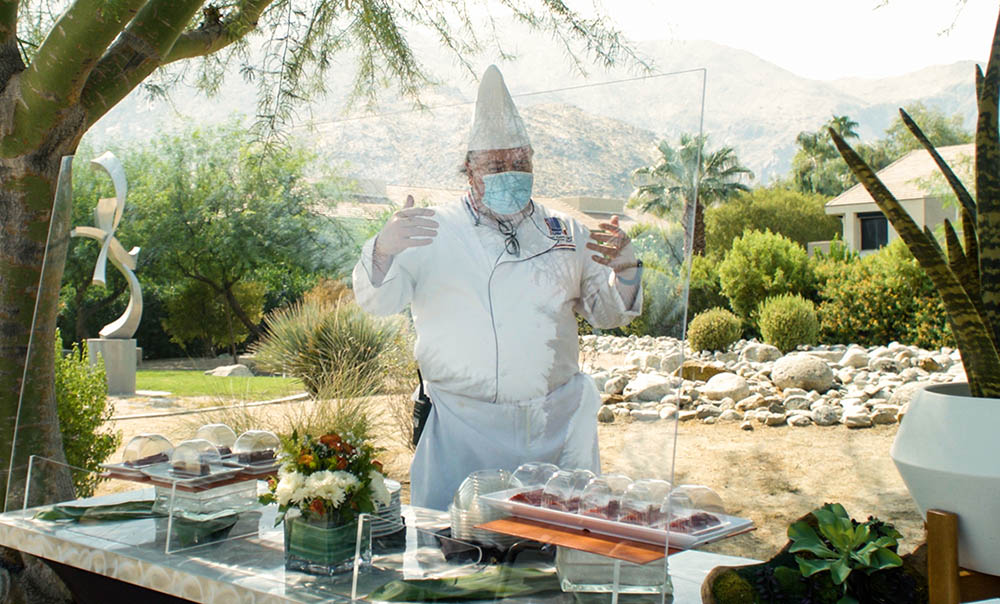 Chef Brad Toles of Savoury’s Catering demonstrates shielded dome station service at the Palm Springs Convention Center.