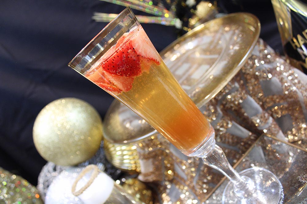 CMPE adds honey and Grand Marnier-soaked strawberries to champagne for a festive holiday enhancement.