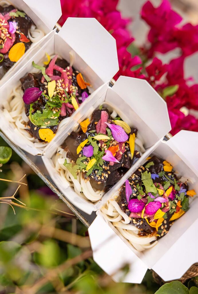 Bites & Bashes in Los Angeles recently served jjajangmyun, a Korean noodle dish, in mini to-go boxes during a wedding cocktail hour.