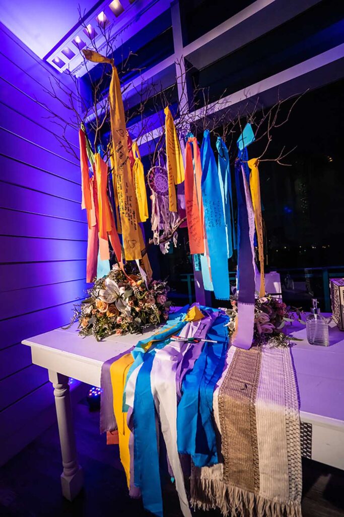 After guests inscribed brightly colored strips of fabric—representing the couple’s travels to Taiwan—Willard and his team had the strips sewn into a blanket for the couple. Photo by Muñoz Photography