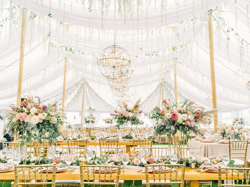 Hanging wisteria and custom florals enhance a wedding designed by Jaclyn Watson Events. Photo by Rodeo & Co.
