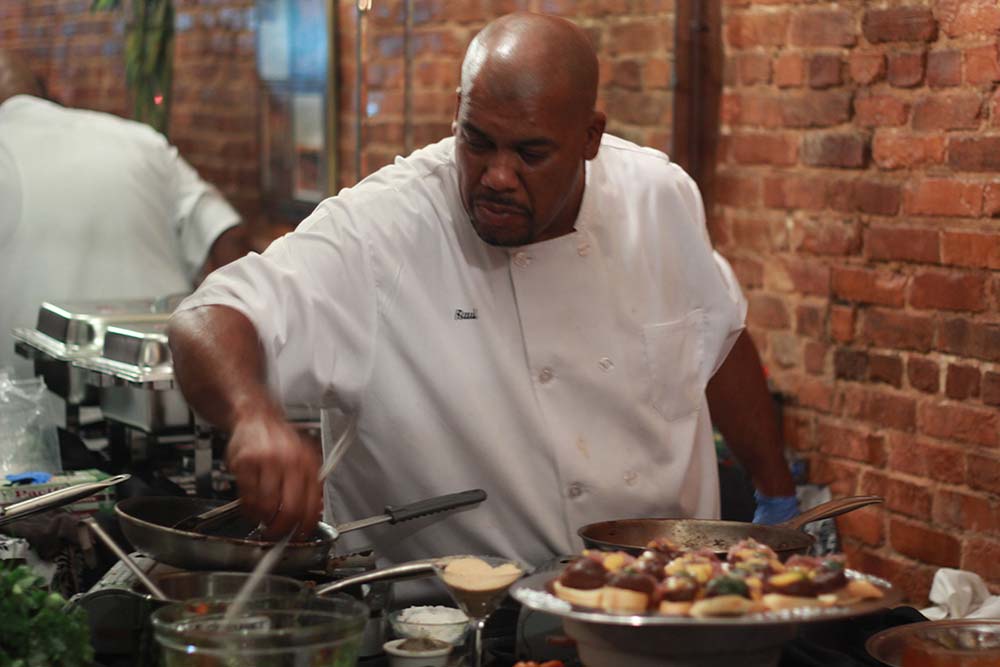 Chef Raúl Thomas cooks at a live action station.