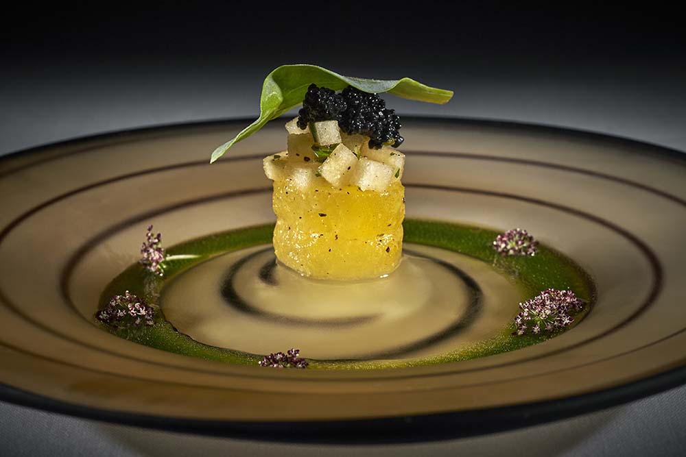 Yellow watermelon tartare with kelp caviar and an oyster leaf, served by Elizabeth’s Gone Raw
