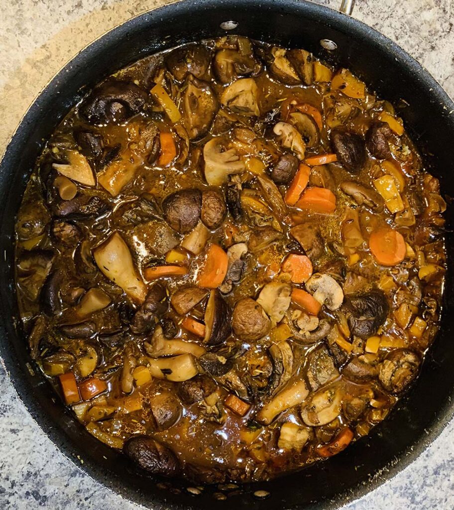 Vegan Catering NYC’s mushroom bourguignon braised with Cabernet wine with carrots and pearl onions