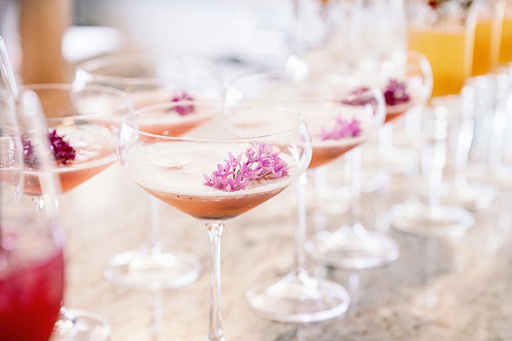 Add eye-catching clusters of flowers to a cocktail for a festive garnish, suggests Melissa Misgen of Elite Events Catering. Photo by Dewitt for Love Photography