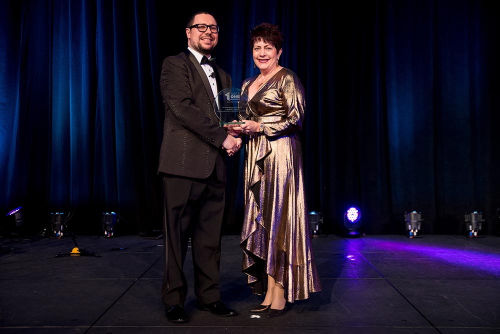 At the NACE One Awards Gala, NACE Past President James Filtz, CPCE, CMP, CHE, presented the Chapter Community Service award to Kay Kolbo of the Las Vegas chapter.