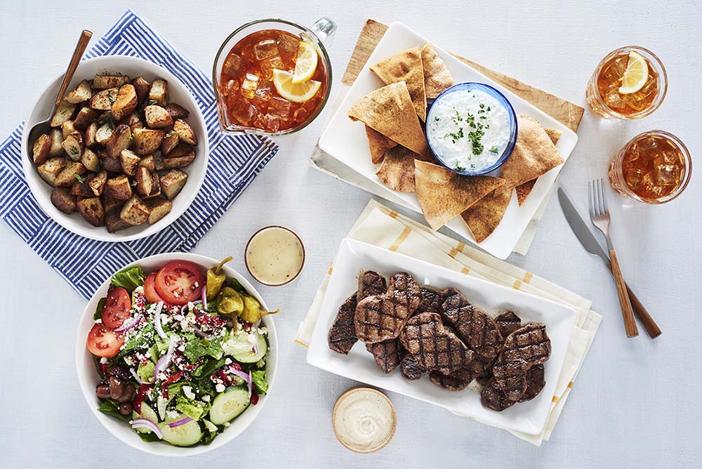 The Lamb Family Feast from Taziki's Mediterranean Cafe, including grilled lamb, salad, roasted potatoes and pita