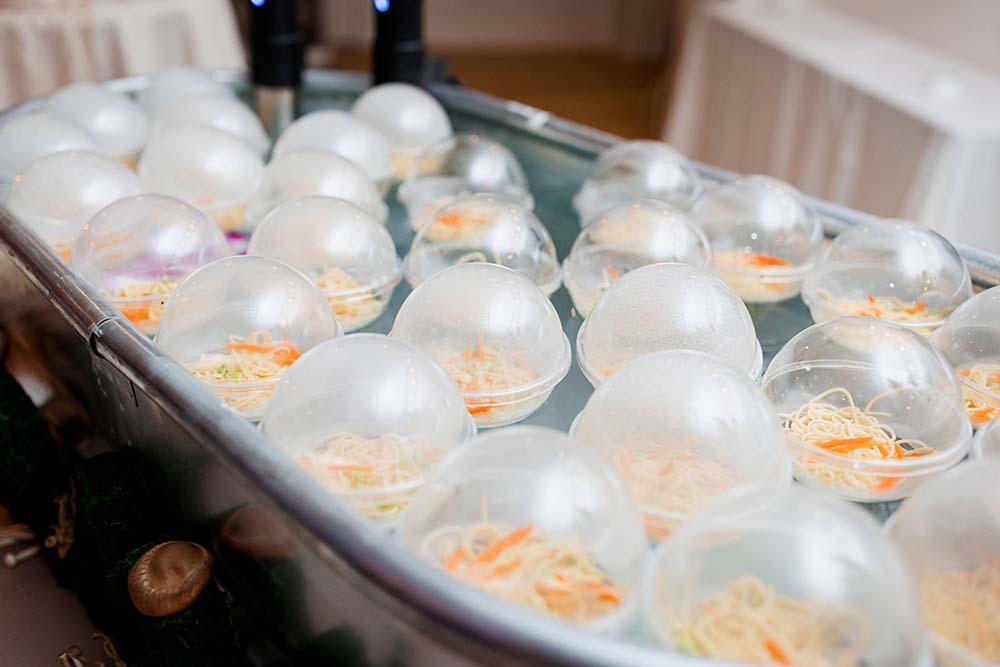 Guests fish a “Ramen Bobbin” out of a tub at Partyman Catering’s Sea Station.