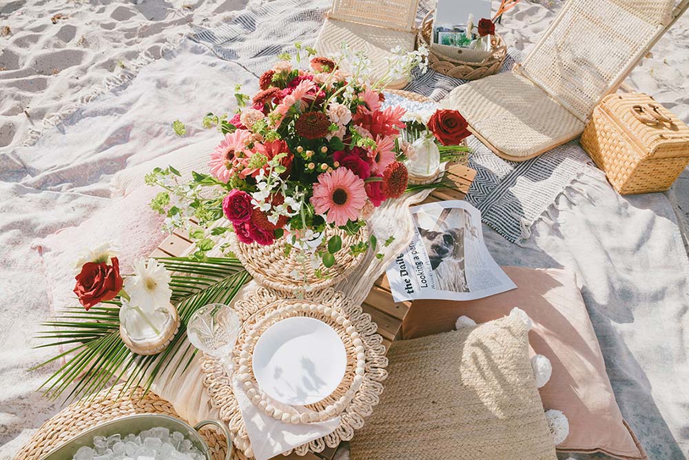 A beach picnic designed by The Little Gatherings. Photo by @florserra.photo