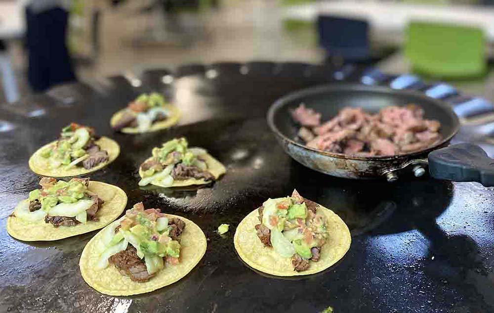 Street tacos with carne asada, tomatillo avocado salsa and pickled cucumber from the Hugh Groman Group