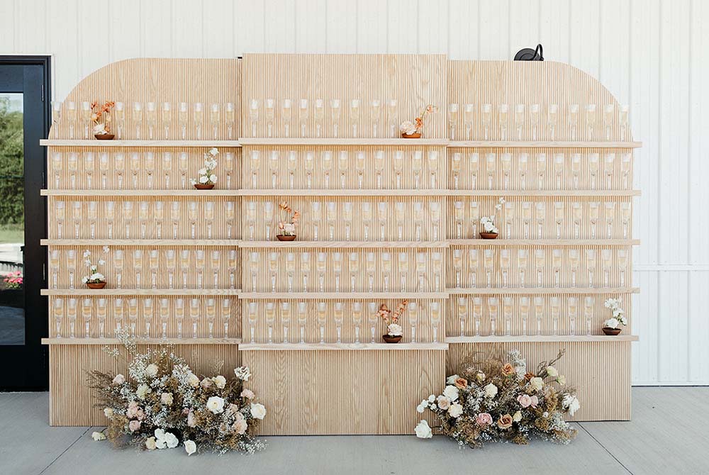 An eye-catching champagne wall, like this one by EVL Events, will have guests reaching for their cameras.