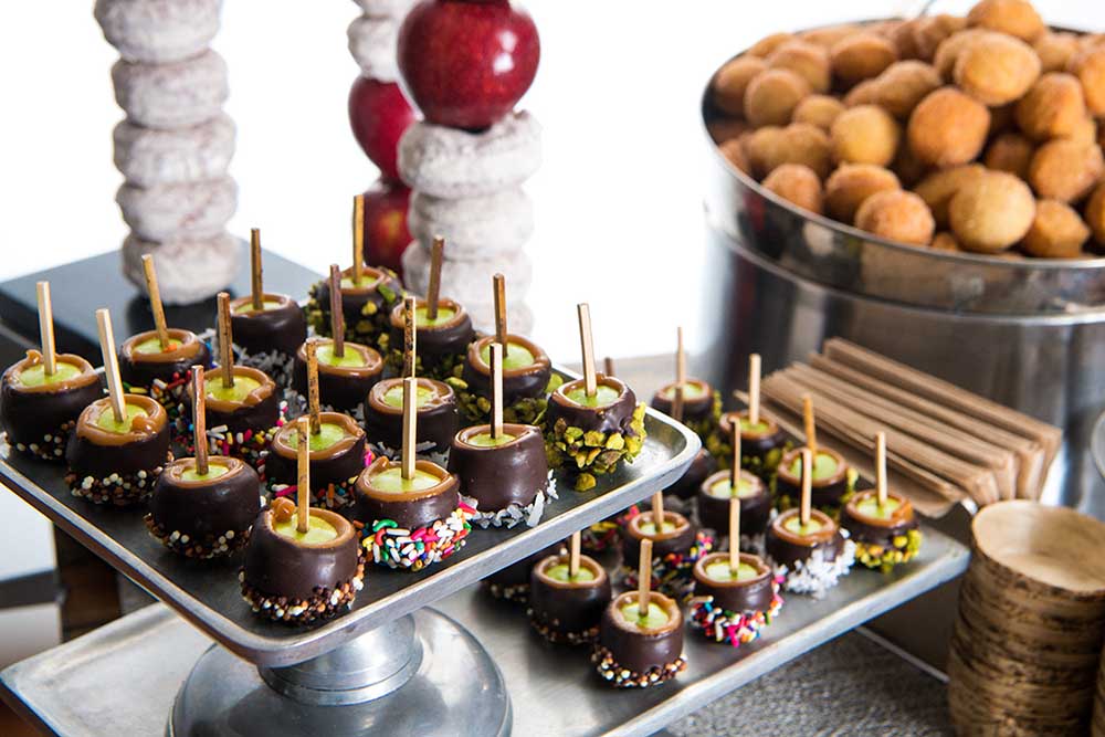 Abigail Kirsch’s Take the Chill Off dessert station, featuring bite-sized caramel apples and warm cinnamon-sugar donut holes